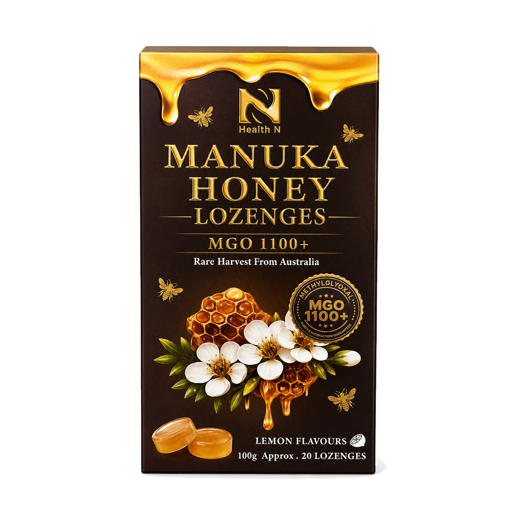 A box of Health N Manuka Honey Lozenges, MGO 1100+, lemon flavour, on a plain white background. The packaging is dark brown with gold lettering and honey graphics, featuring illustrations of honeycomb, white flowers, and bees.